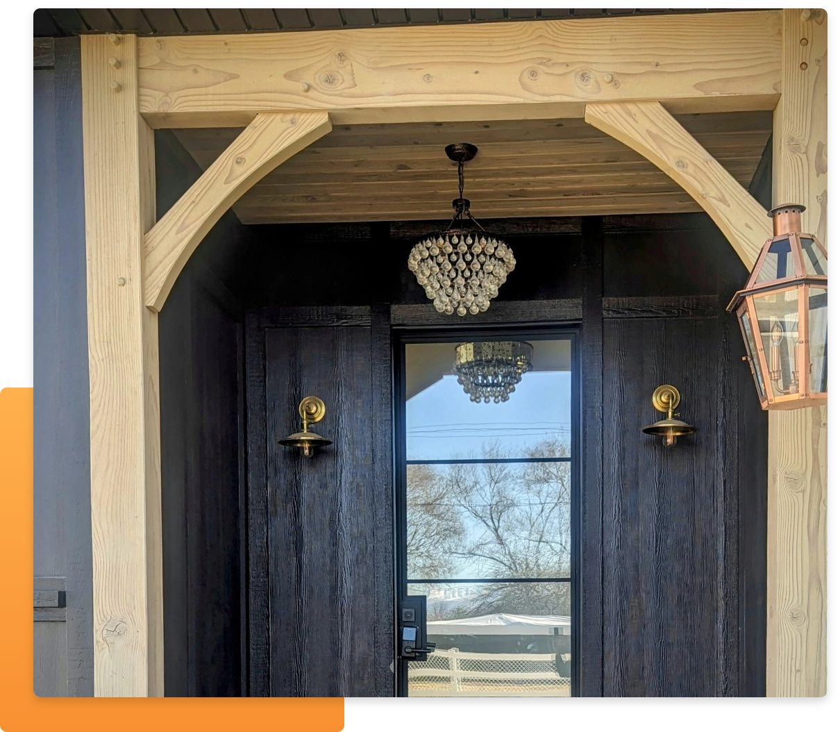 Quest Siding, an image of  part of a structure with dark siding in front of at least part of a an orange rectangle with rounded corners