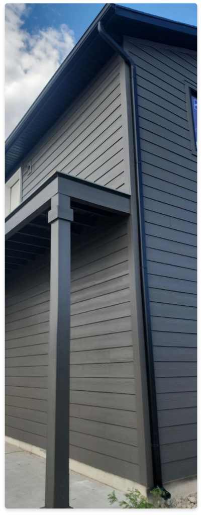 Our Process, an image of part of a structure with dark siding