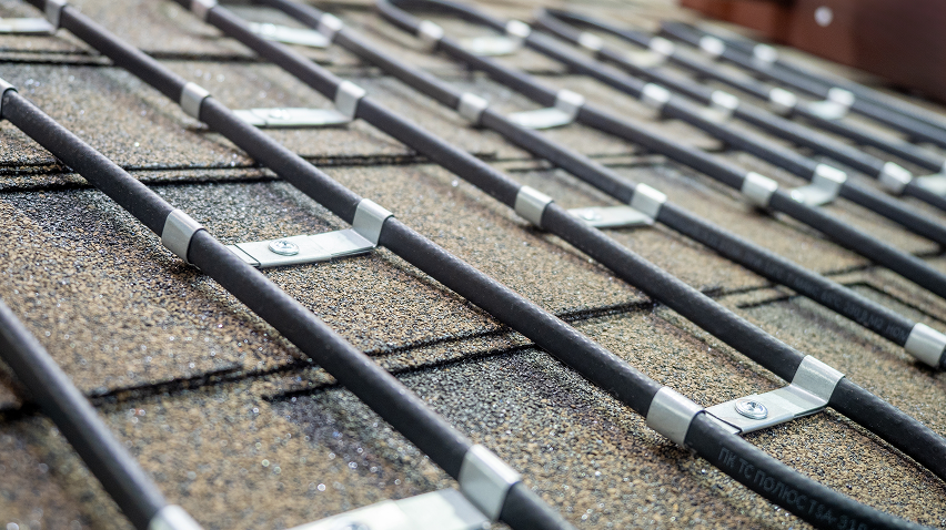 Equipment installed on roof and secured using metal brackets